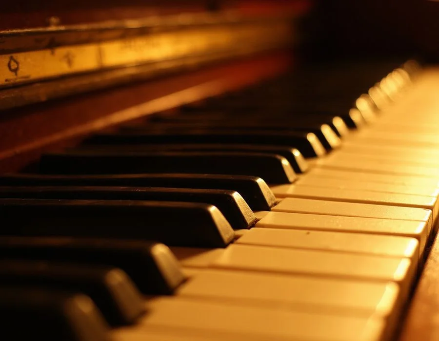 Detail of ivory keys under warm gold light
